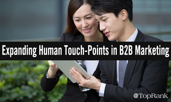 Expanding human touch-points in B2B marketing business people outdoors looking at mobile device image
